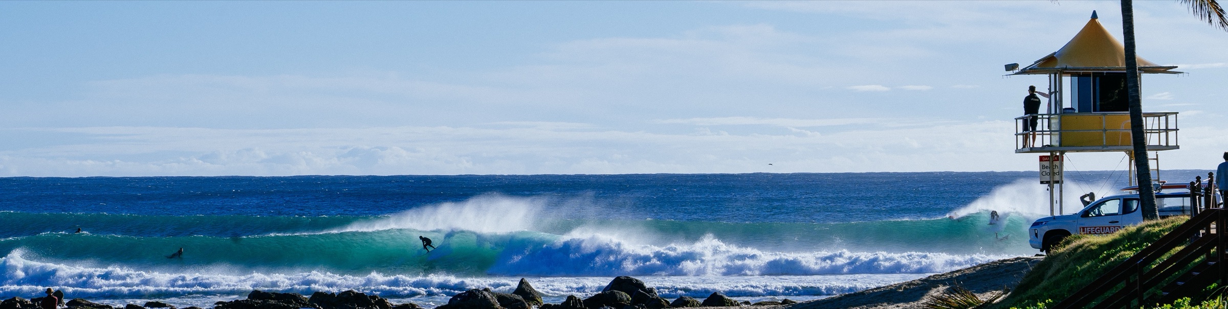 Waves peel past the lifeguard tower at Snapper Rocks